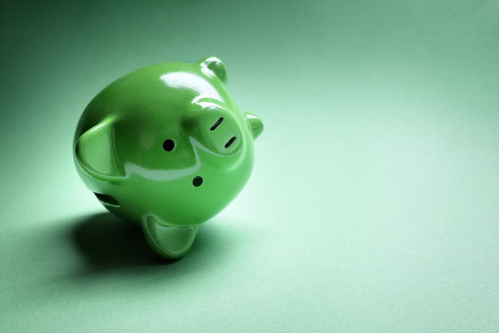 Green upside down piggy bank on a green background